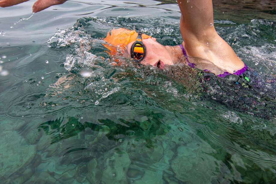 An open water swimmer wearing the Zoggs predator flex titanium during a sea swim.