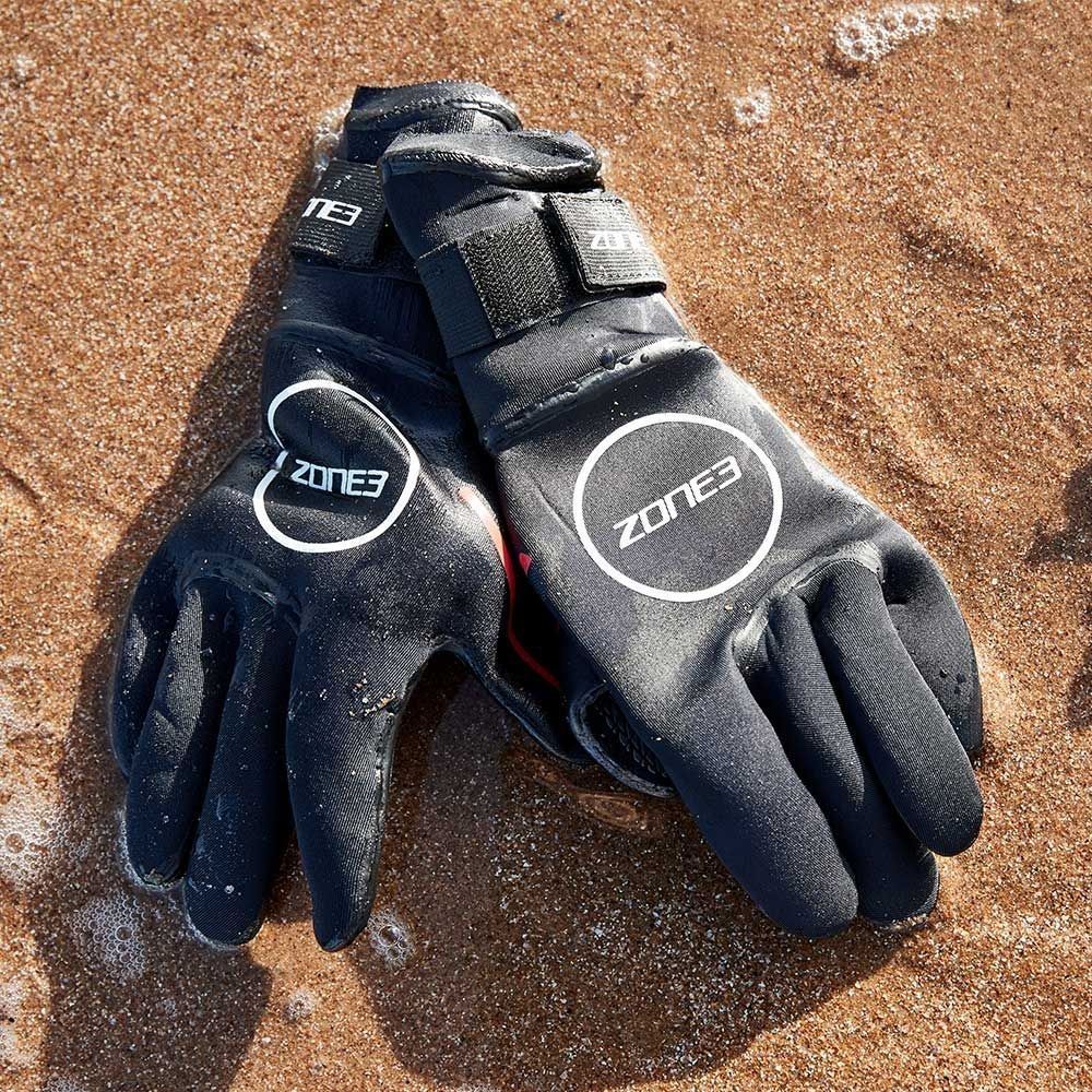 Close-up of Zone3 Heat-Tech neoprene swimming gloves showing textured palm grip and Smoothskin wrist closure.