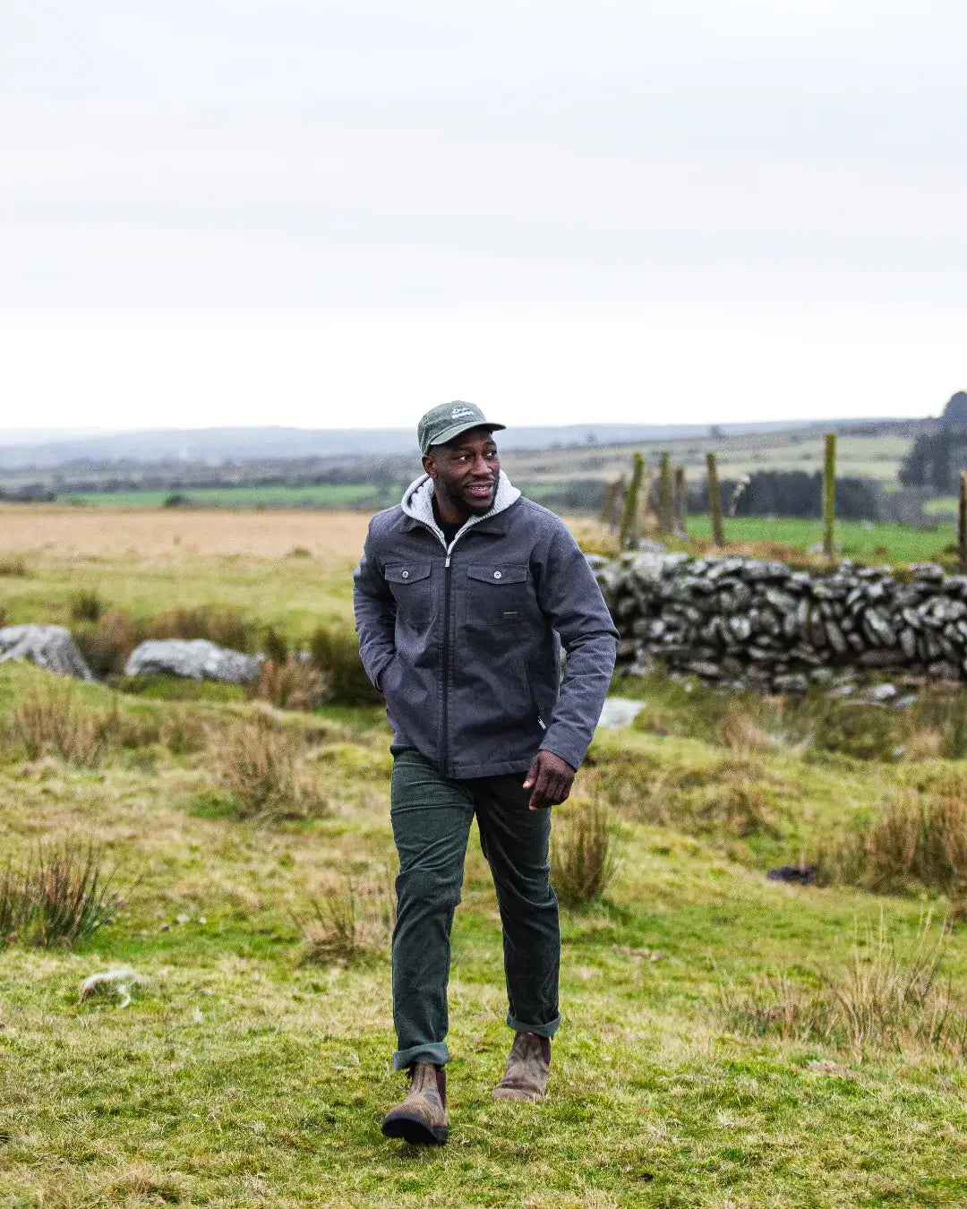 Bleubird Aspen jacket in navy being worn by a walker. 