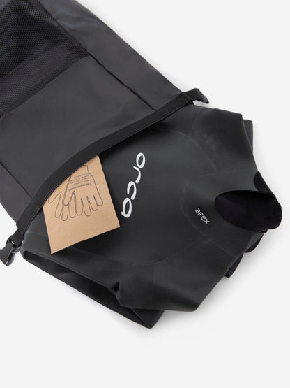 Orca Apex Flow wetsuit being put into a dry. bag.