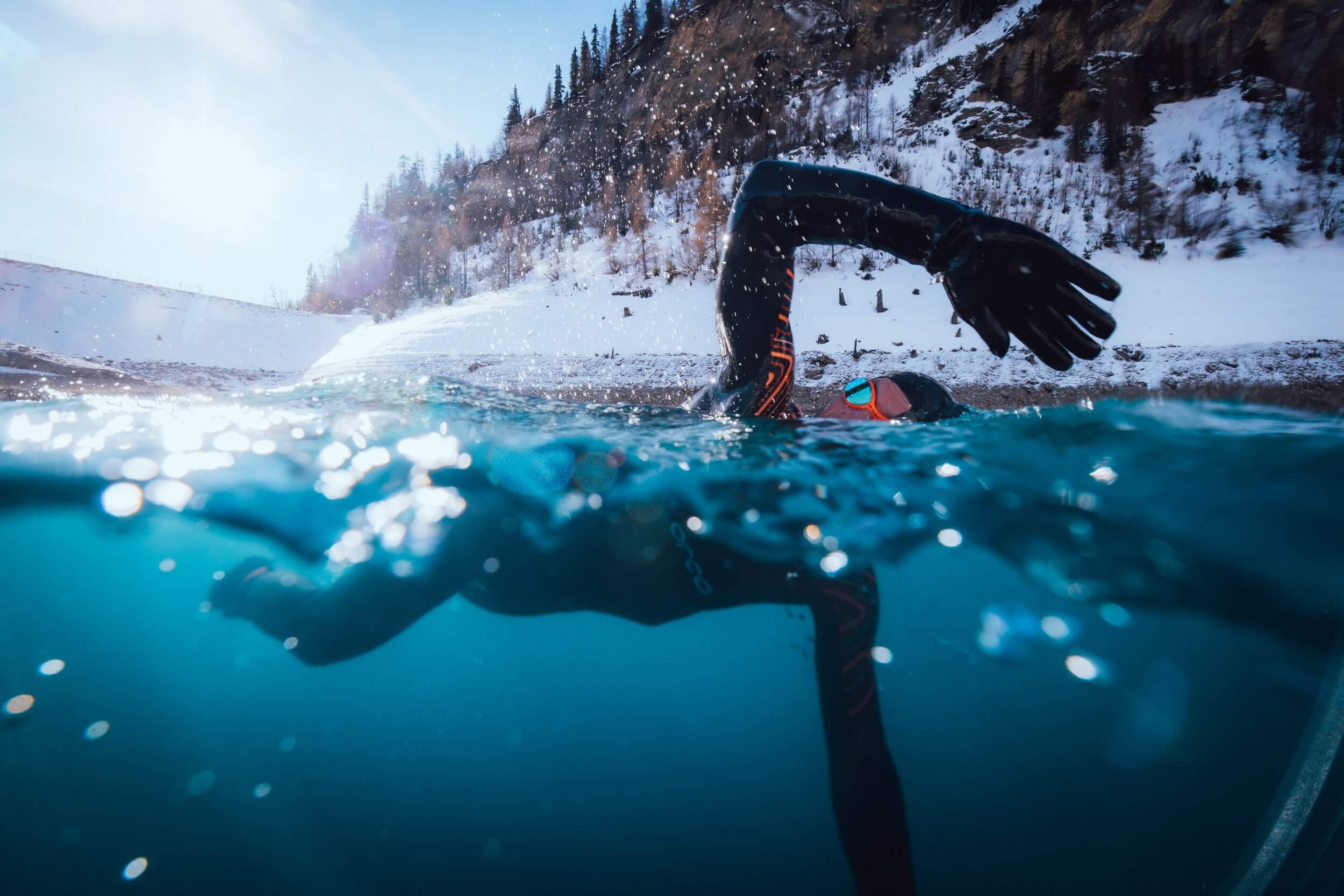 An open water swimmer taking a dip in their Orca wetsuit.
