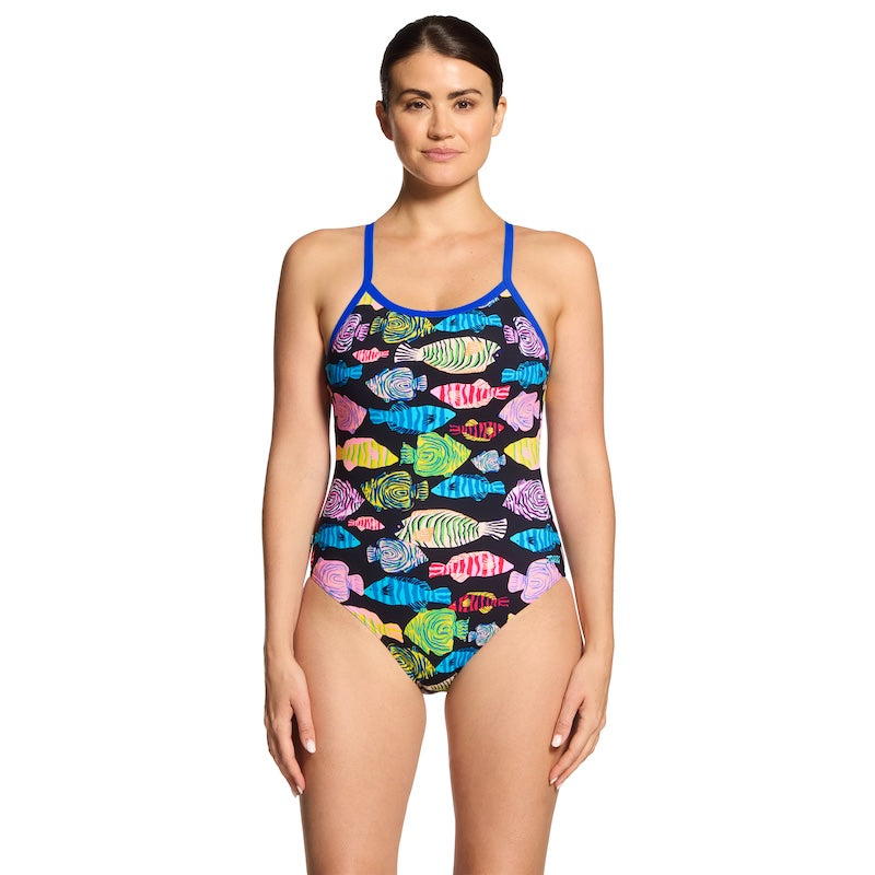 Woman wearing a colorful fish-patterned swimsuit on a white background by Zoggs.