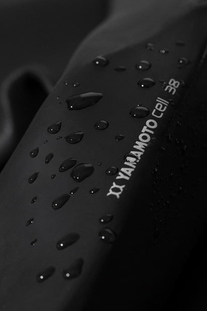 Open water swimming wetsuit leg detail showing yamamoto neoprene logo with water droplets. 