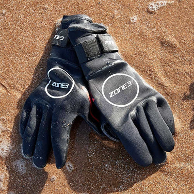 Close-up of Zone3 Heat-Tech neoprene swimming gloves showing textured palm grip and Smoothskin wrist closure.