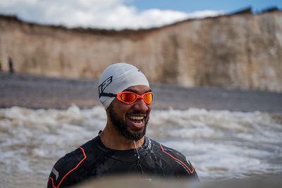 An open water swimmer wearing the Zone3 Attack goggles in the Sea at Beachy Head 