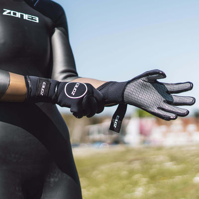 Zone3 heat tech gloves showing their velcro strap to keep your hands warm during cold water swims.